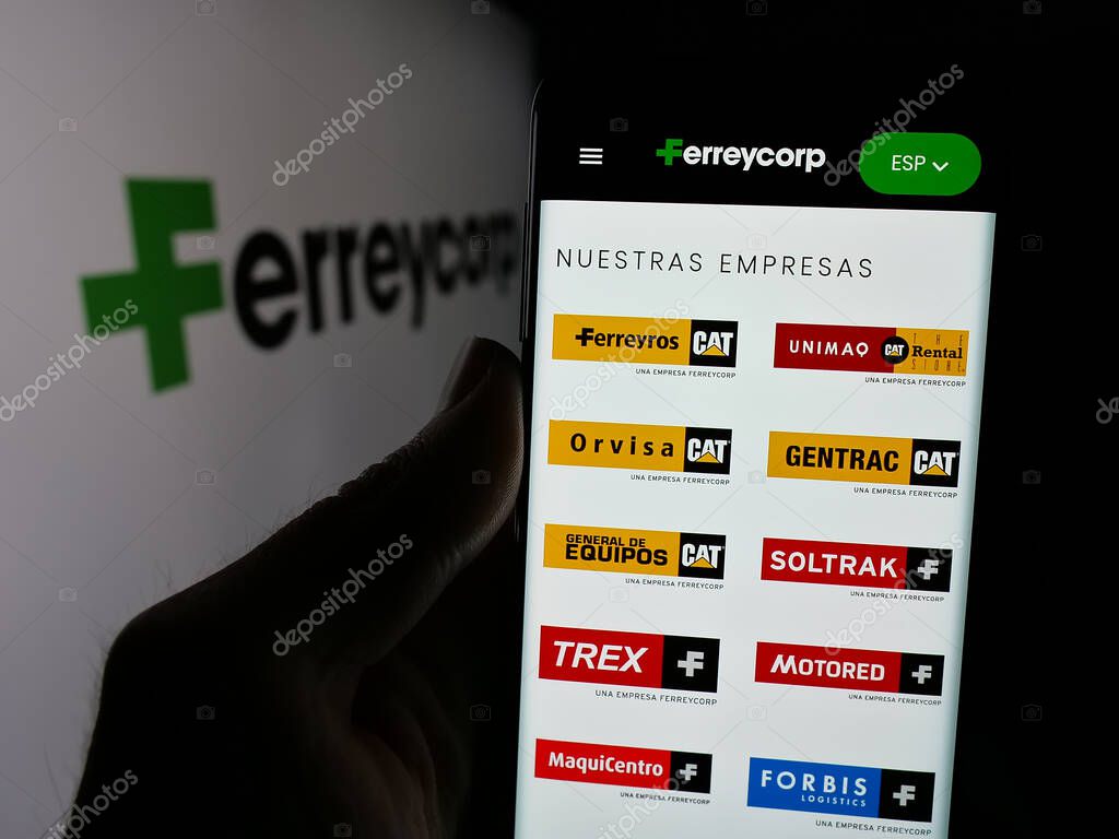 Stuttgart, Germany - 04-17-2025: Person holding cellphone with web page of Peruvian machinery company Ferreycorp S.A.A. on screen in front of logo. Focus on center of phone display.