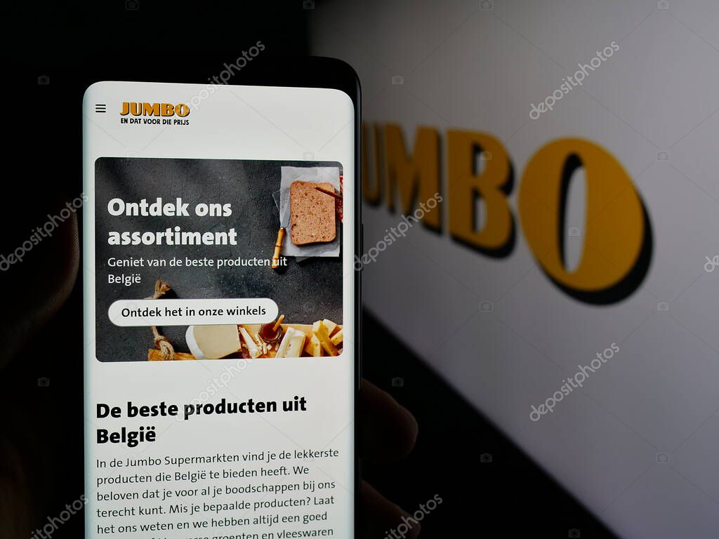 Stuttgart, Germany - 04-17-2025: Person holding smartphone with website of Dutch company Koninklijke Jumbo Food Groep on screen in front of logo. Focus on center of phone display.