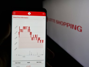 Stuttgart, Almanya - 04-24-2025: Logo önünde ekranda Lotte Shopping Co. Ltd. perakende şirketinin web sayfası ile cep telefonu tutan kişi. Telefon ekranının merkezine odaklan.