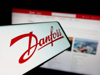 Stuttgart, Almanya - 04-24-2025: Danfoss AS adlı Danimarkalı HVAC şirketinin logosuna sahip akıllı telefon web sitesinin önünde ekranda. Telefon ekranının soluna odaklan.