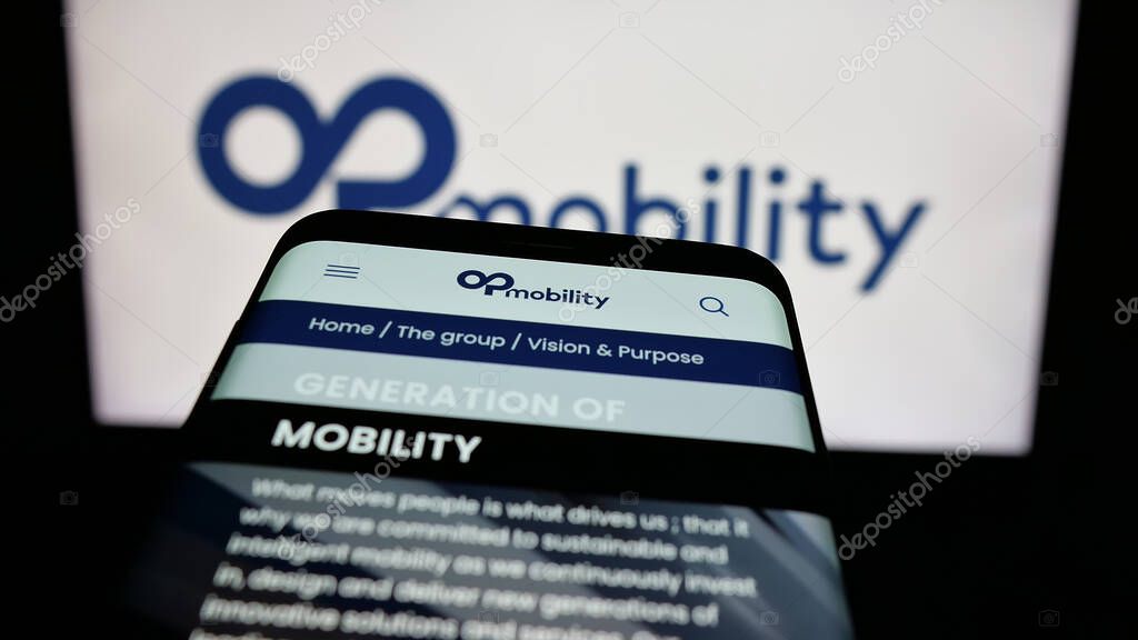 Stuttgart, Germany - 04-24-2025: Mobile phone with webpage of Franch automotive company OPmobility SE on screen in front of logo. Focus on top-left of phone display.