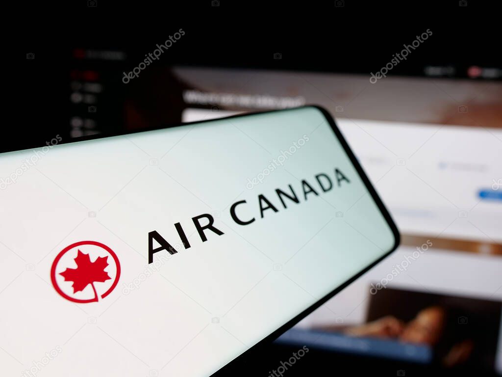 Stuttgart, Germany - 04-25-2025: Smartphone with logo of Canadian airline company Air Canada on screen in front of website. Focus on center-left of phone display.