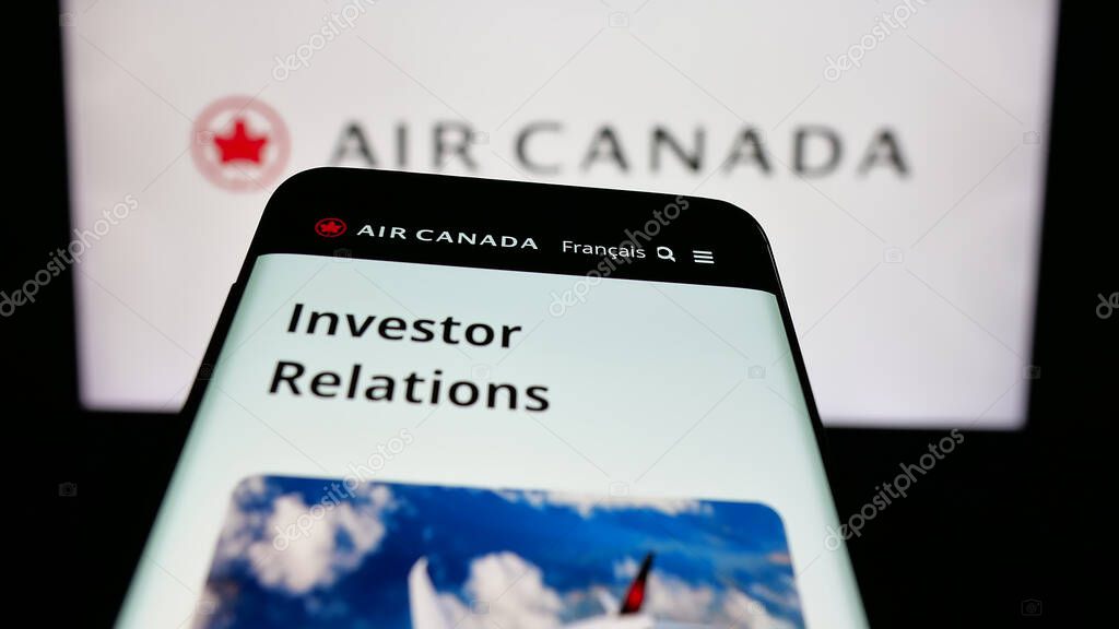 Stuttgart, Germany - 04-25-2025: Mobile phone with webpage of Canadian airline company Air Canada on screen in front of logo. Focus on top-left of phone display.
