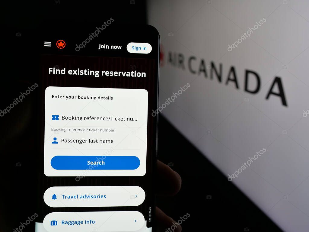 Stuttgart, Germany - 04-25-2025: Person holding cellphone with web page of Canadian airline company Air Canada on screen in front of logo. Focus on center of phone display.