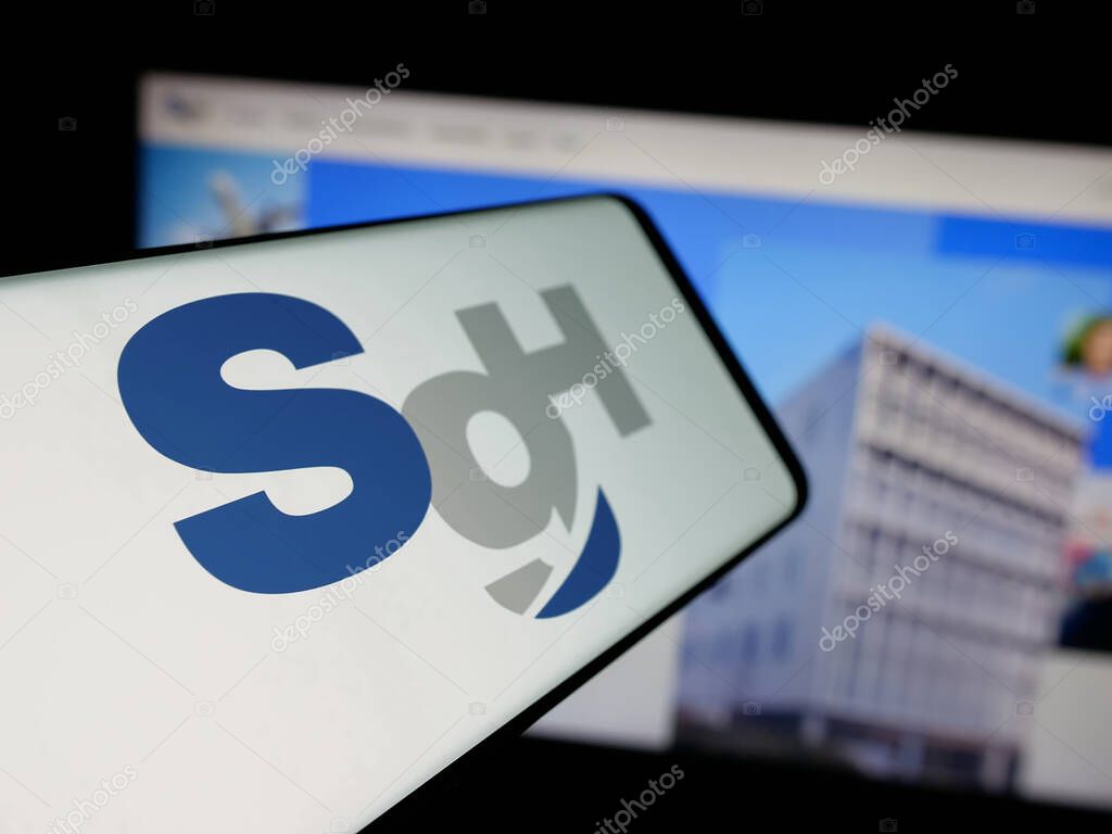 Stuttgart, Germany - 04-26-2025: Smartphone with logo of logistics company SG Holdings Co. Ltd. on screen in front of website. Focus on center-left of phone display.