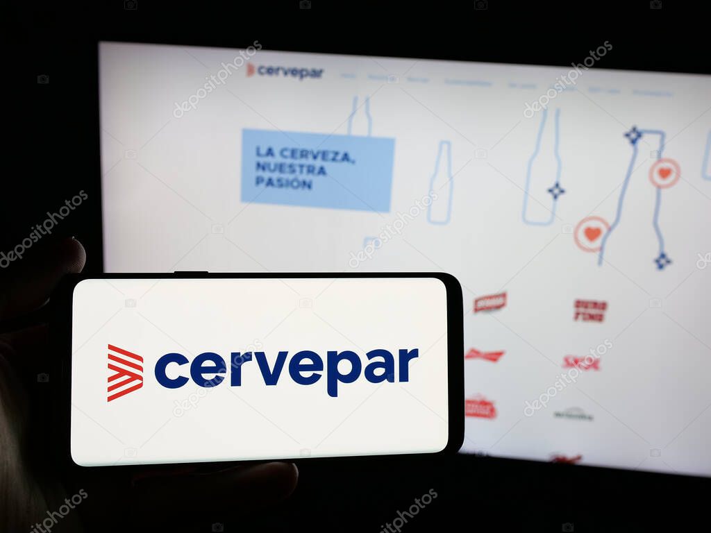 Stuttgart, Germany - 05-03-2025: Person holding smartphone with logo of company Cerveceria Paraguaya S.A. (Cervepar) on screen in front of website. Focus on phone display.