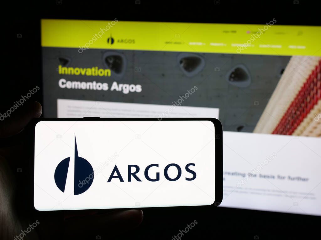 Stuttgart, Germany - 05-04-2025: Person holding smartphone with logo of building materials company Grupo Argos S.A. on screen in front of website. Focus on phone display.