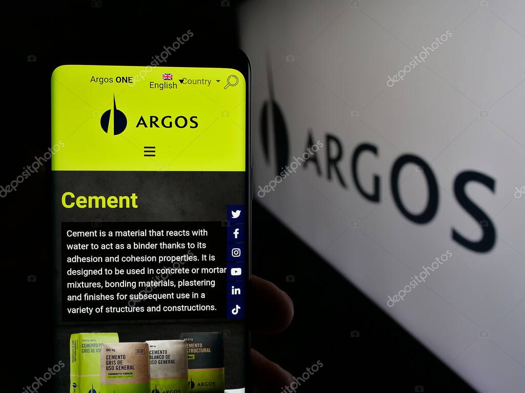 Stuttgart, Germany - 05-04-2025: Person holding smartphone with website of building materials company Grupo Argos S.A. on screen in front of logo. Focus on center of phone display.