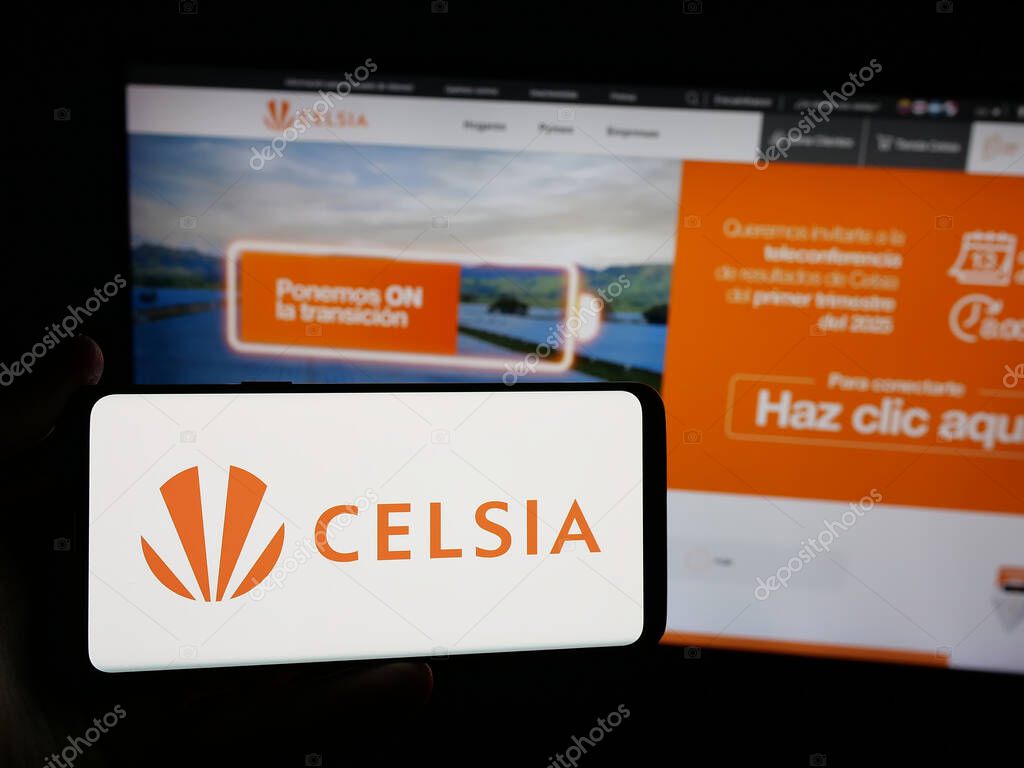 Stuttgart, Germany - 05-05-2025: Person holding smartphone with logo of Colombian energy company Celsia S.A. E.S.P. on screen in front of website. Focus on phone display.