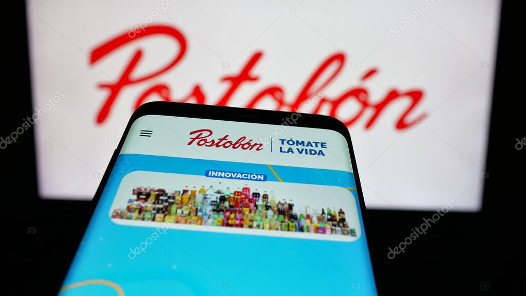 Stuttgart, Germany - 05-05-2025: Mobile phone with logo of Colombian beverage company Postobon S.A. on screen in front of website. Focus on top-left of phone display.