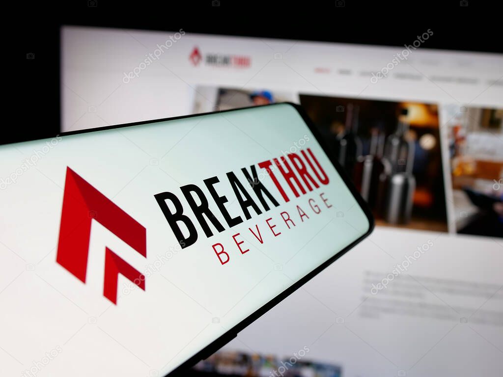 Stuttgart, Germany - 05-06-2025: Smartphone with logo of US company Breakthru Beverage Group LLC on screen in front of website. Focus on center-left of phone display.
