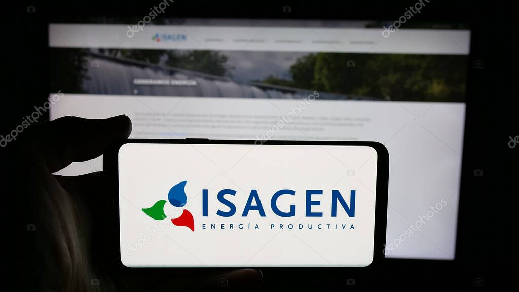 Stuttgart, Germany - 05-06-2025: Person holding cellphone with logo of Colombian energy company Isagen S.A. E.S.P. on screen in front of webpage. Focus on phone display.