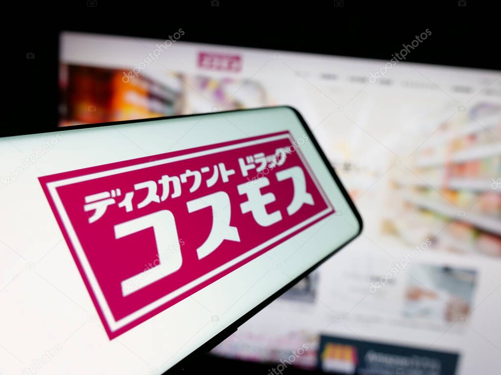 Stuttgart, Germany - 05-14-2025: Smartphone with logo of Japanese company COSMOS Pharmaceutical Corp. on screen in front of website. Focus on center-left of phone display.