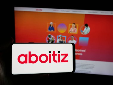 Stuttgart, Almanya - 05-15-2025: Web sitesinin önünde üzerinde Aboitiz Equity Ventures Inc. (AEV) logosu bulunan kişi. Telefon ekranına odaklan.