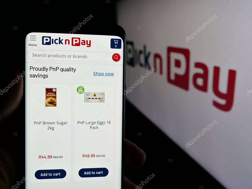 Stuttgart, Germany - 05-14-2025: Person holding cellphone with webpage of grocery retail company Pick n Pay Group Ltd. on screen in front of logo. Focus on center of phone display.