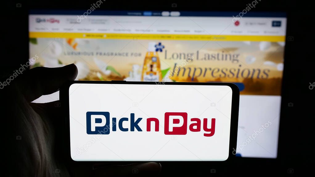 Stuttgart, Germany - 05-14-2025: Person holding cellphone with logo of grocery retail company Pick n Pay Group Ltd. on screen in front of webpage. Focus on phone display.