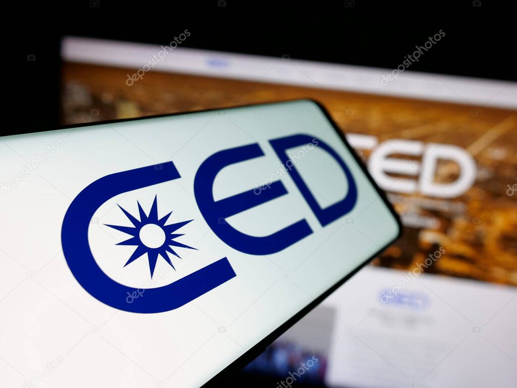 Stuttgart, Germany - 05-15-2025: Smartphone with logo of Consolidated Electrical Distributors (CED) on screen in front of website. Focus on center-left of phone display.