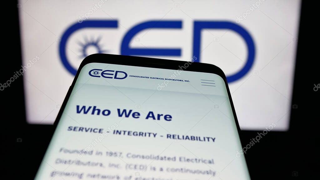 Stuttgart, Germany - 05-15-2025: Mobile phone with website of Consolidated Electrical Distributors (CED) on screen in front of logo. Focus on top-left of phone display.