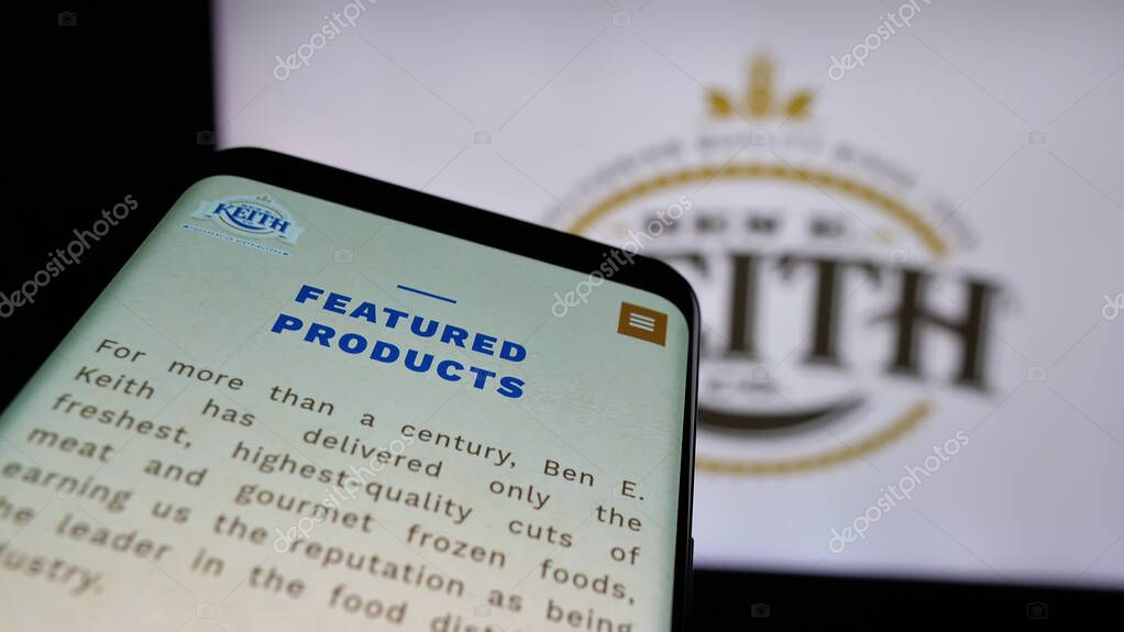 Stuttgart, Germany - 05-16-2025: Mobile phone with website of US distribution business Ben E. Keith Company on screen in front of logo. Focus on top-left of phone display.