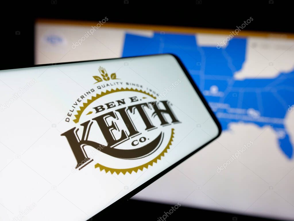 Stuttgart, Germany - 05-16-2025: Smartphone with logo of US distribution business Ben E. Keith Company on screen in front of website. Focus on center-left of phone display.