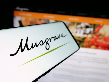 Stuttgart, Almanya - 05-17-2025: İrlandalı gıda şirketi Musgrave Group Ltd. 'nin logosuna sahip akıllı telefon web sitesinin önünde ekranda. Telefon ekranının merkez soluna odaklan.