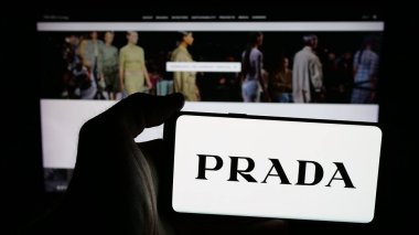 Stuttgart, Almanya - 05-17-2025: Lüks moda evi şirketi Prada S.P.A. 'nın logosunun bulunduğu cep telefonu web sayfasının önünde duruyor. Telefon ekranına odaklan.
