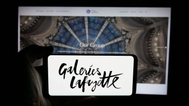Stuttgart, Almanya - 05-17-2025: Alışveriş merkezi şirketi Galeries Lafayette 'in logosunun bulunduğu cep telefonu web sayfası önünde ekranda. Telefon ekranına odaklan.