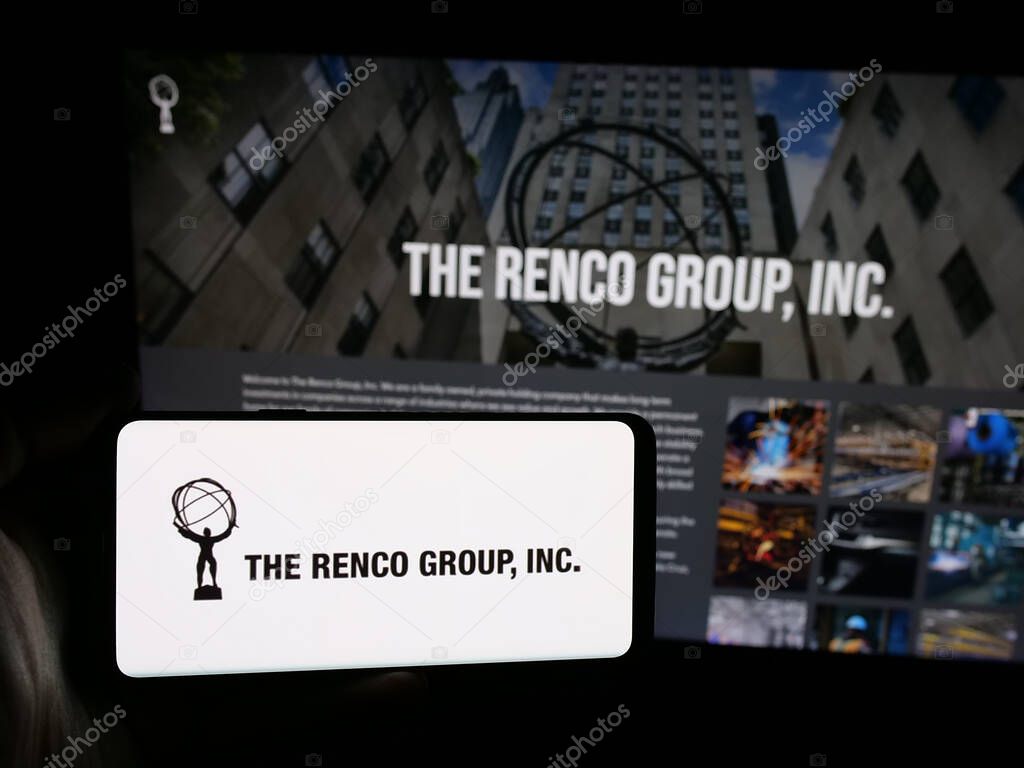Stuttgart, Germany - 05-17-2025: Person holding smartphone with logo of US holding company The Renco Group Inc. on screen in front of website. Focus on phone display.