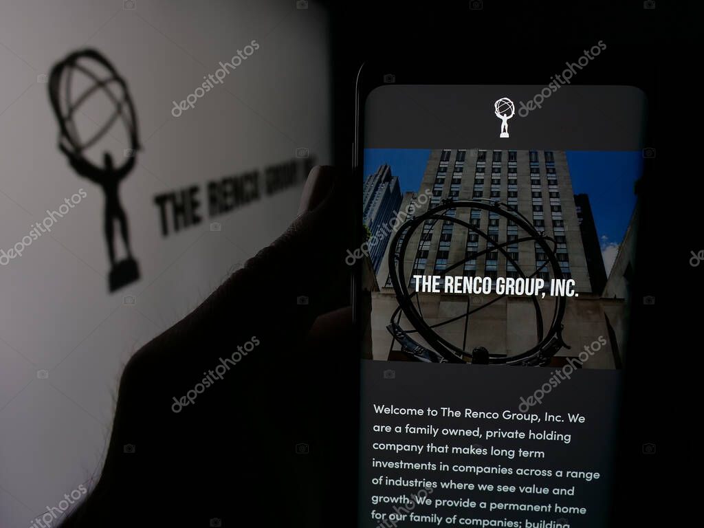 Stuttgart, Germany - 05-17-2025: Person holding smartphone with web page of US holding company The Renco Group Inc. on screen in front of logo. Focus on center of phone display.