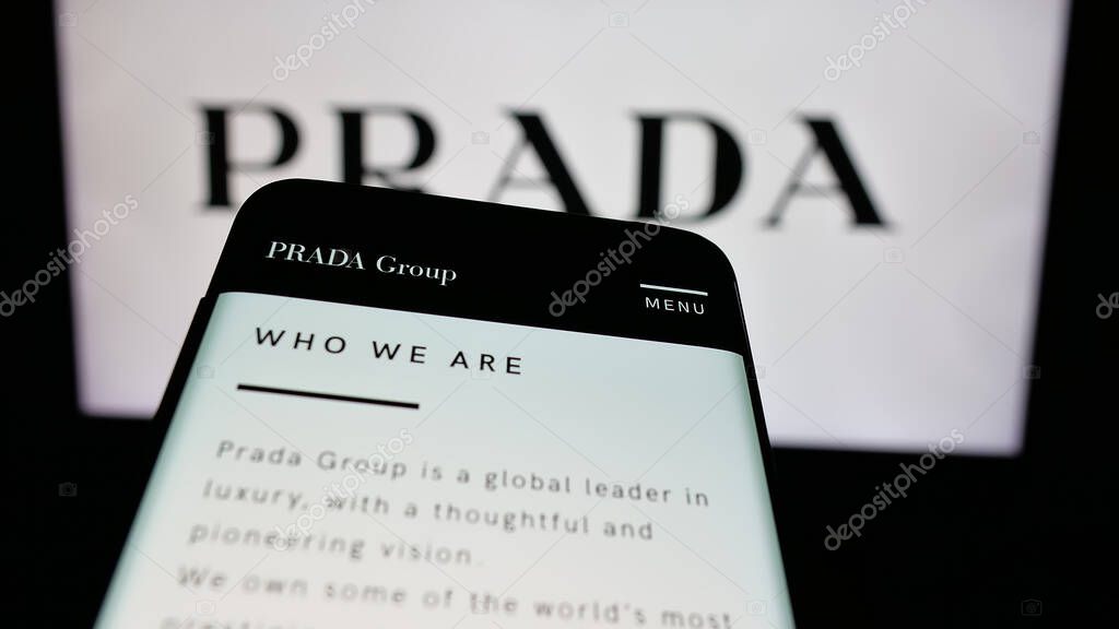 Stuttgart, Germany - 05-17-2025: Mobile phone with website of luxury fashion house company Prada S.p.A. on screen in front of logo. Focus on top-left of phone display.