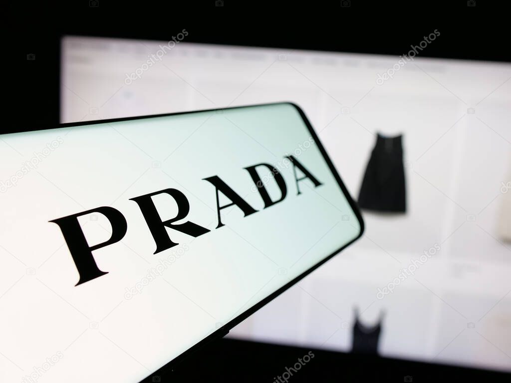 Stuttgart, Germany - 05-17-2025: Smartphone with logo of luxury fashion house company Prada S.p.A. on screen in front of website. Focus on center-left of phone display.