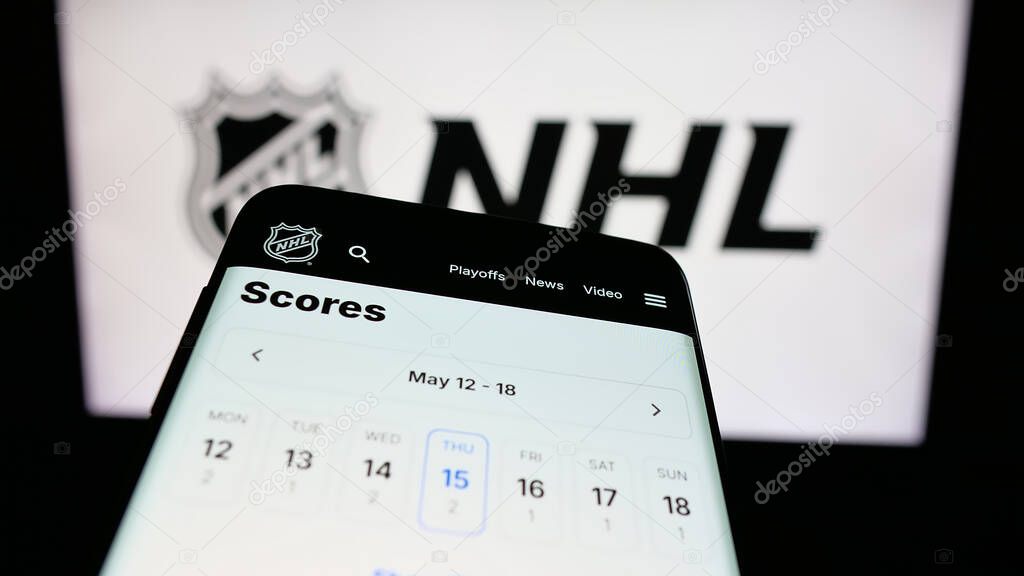 Stuttgart, Germany - 05-18-2025: Mobile phone with website of National Hockey League (NHL) on screen in front of logo. Focus on top-left of phone display.