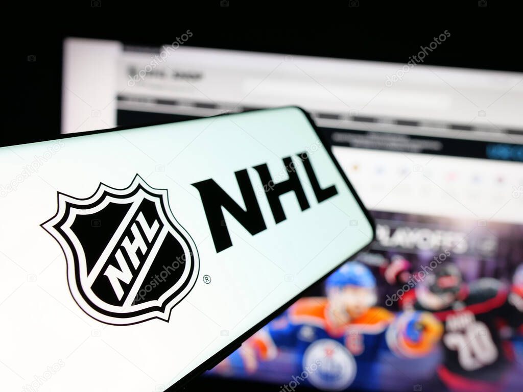 Stuttgart, Germany - 05-18-2025: Smartphone with logo of National Hockey League (NHL) on screen in front of website. Focus on center-left of phone display.