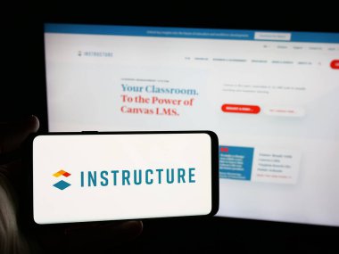Stuttgart, Almanya - 05-27-2025: ABD 'li Edtech şirketi Instructure Holding Inc.' nin logosuna sahip akıllı telefon sahibi kişi web sitesinin önünde ekranda. Telefon ekranına odaklan.