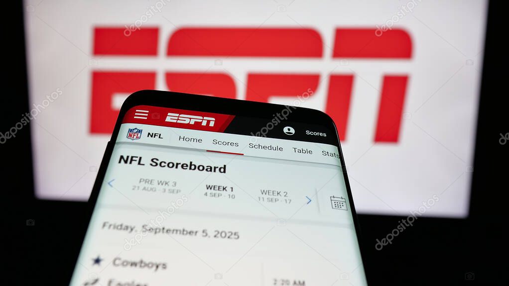 Stuttgart, Germany - 05-27-2025: Mobile phone with website of US cable sports television channel ESPN on screen in front of logo. Focus on top-left of phone display.