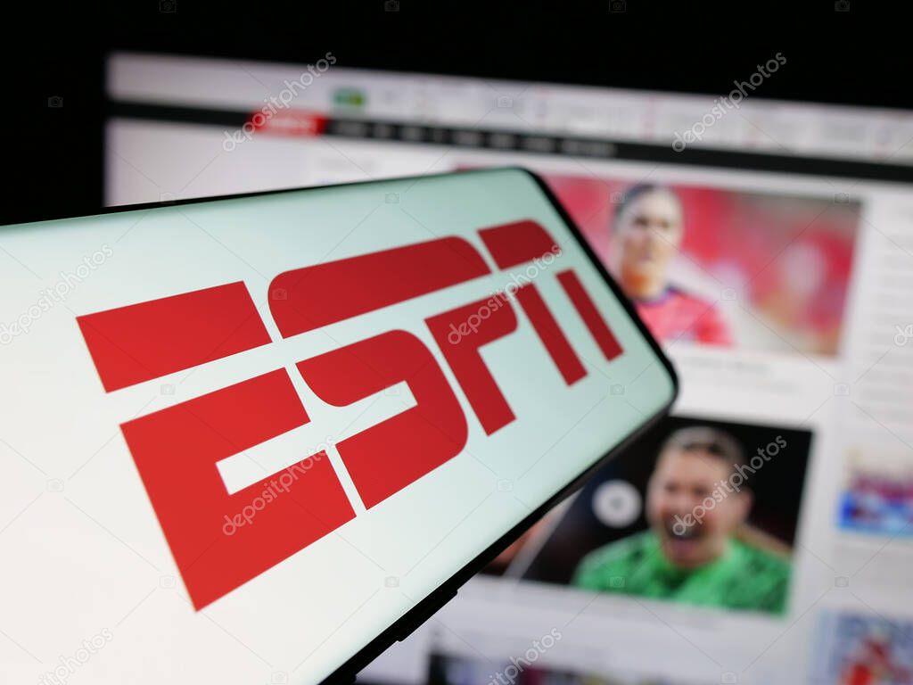 Stuttgart, Germany - 05-27-2025: Smartphone with logo of US cable sports television channel ESPN on screen in front of website. Focus on center-left of phone display.