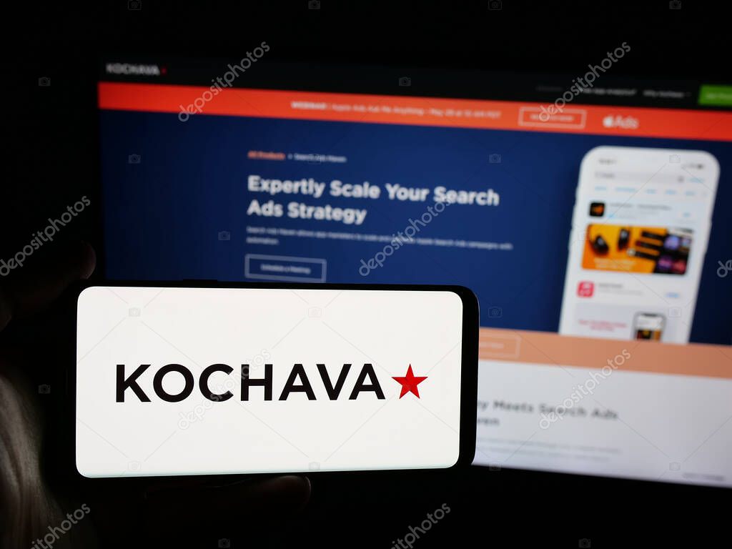 Stuttgart, Germany - 05-29-2025: Person holding smartphone with logo of US data solutions company Kochava Inc. on screen in front of website. Focus on phone display.