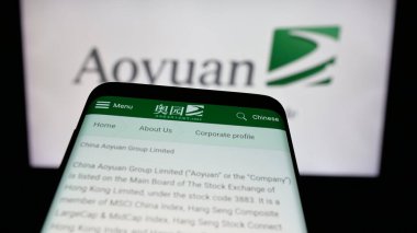 Stuttgart, Almanya - 06-02-2025: Mülk şirketi Aoyuan Group Limited 'in web sitesiyle birlikte cep telefonu logonun önünde ekranda. Telefon ekranının sol üst kısmına odaklan.
