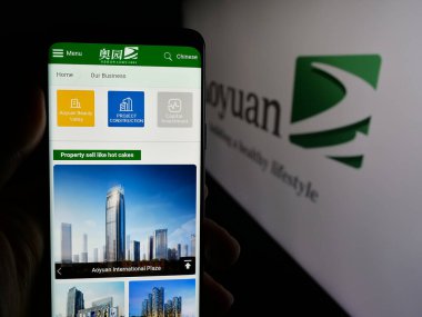 Stuttgart, Almanya - 06-02-2025: Mülk şirketi Aoyuan Group Limited 'in internet sayfası olan cep telefonu logonun önünde ekranda. Telefon ekranının merkezine odaklan.