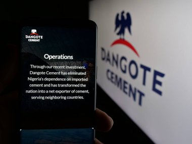 Stuttgart, Almanya - 06-05-2025: Nijeryalı malzeme şirketi Dangote Cement plc 'in web sayfası olan cep telefonu logosu önünde ekranda. Telefon ekranının merkezine odaklan.
