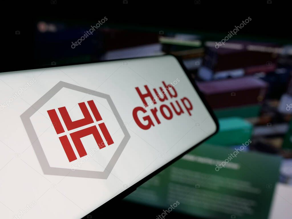 Stuttgart, Germany - 05-31-2025: Smartphone with logo of US logistics company Hub Group Inc. on screen in front of website. Focus on center-left of phone display.