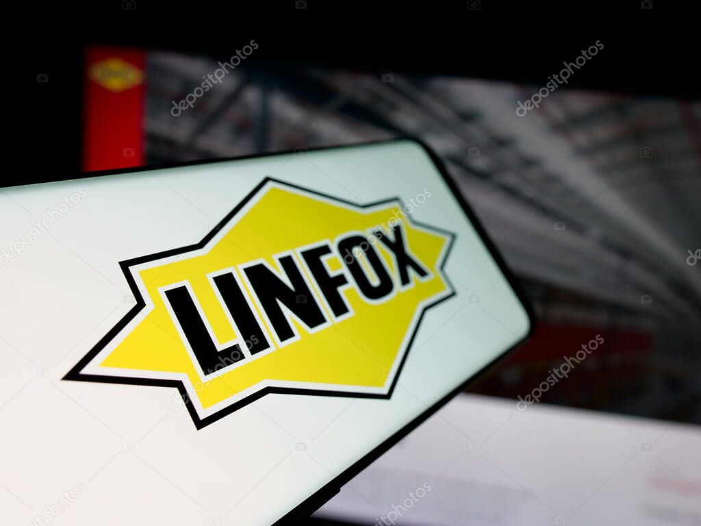 Stuttgart, Germany - 06-05-2025: Smartphone with logo of Australian logistics company Linfox Pty. Ltd. on screen in front of website. Focus on center-left of phone display.
