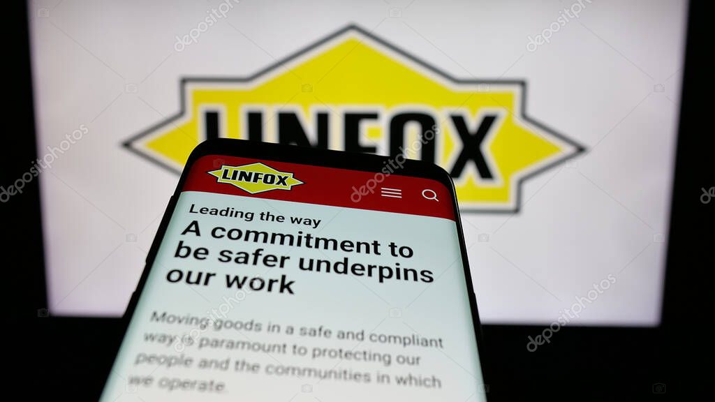 Stuttgart, Germany - 06-05-2025: Mobile phone with website of Australian logistics company Linfox Pty. Ltd. on screen in front of logo. Focus on top-left of phone display.