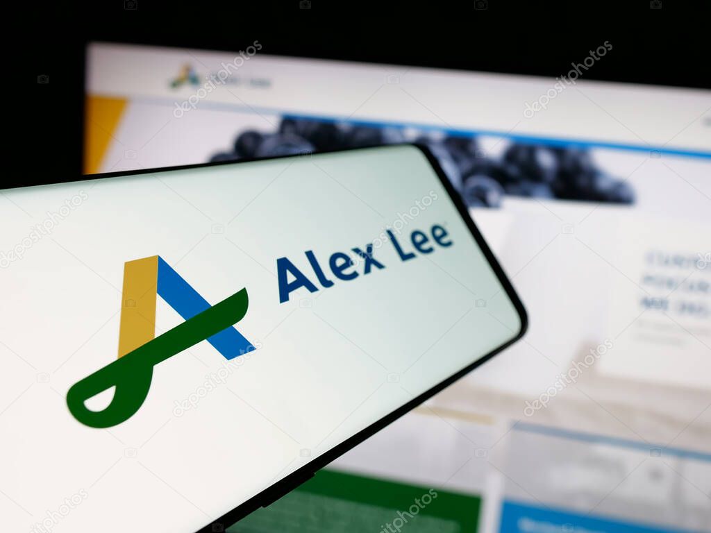 Stuttgart, Germany - 06-05-2025: Smartphone with logo of US grocery wholesale company Alex Lee Inc. on screen in front of website. Focus on center-left of phone display.
