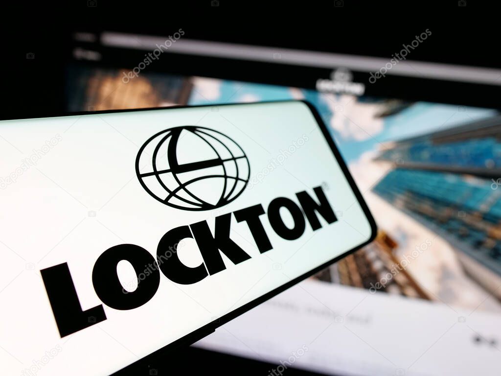 Stuttgart, Germany - 06-05-2025: Smartphone with logo of financial services company Lockton Companies on screen in front of website. Focus on center-left of phone display.