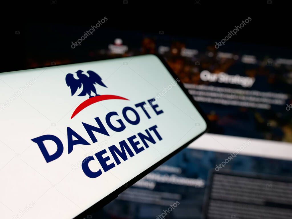 Stuttgart, Germany - 06-05-2025: Smartphone with logo of Nigerian materials company Dangote Cement plc on screen in front of website. Focus on center-left of phone display.