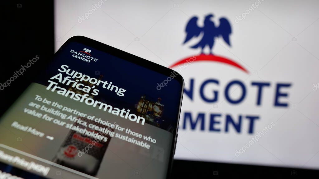 Stuttgart, Germany - 06-05-2025: Mobile phone with website of Nigerian materials company Dangote Cement plc on screen in front of logo. Focus on top-left of phone display.