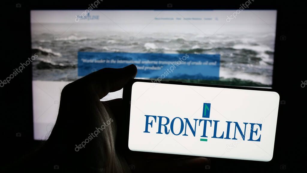 Stuttgart, Germany - 06-06-2025: Person holding mobile phone with logo of oil tanker shipping company Frontline plc on screen in front of web page. Focus on phone display.