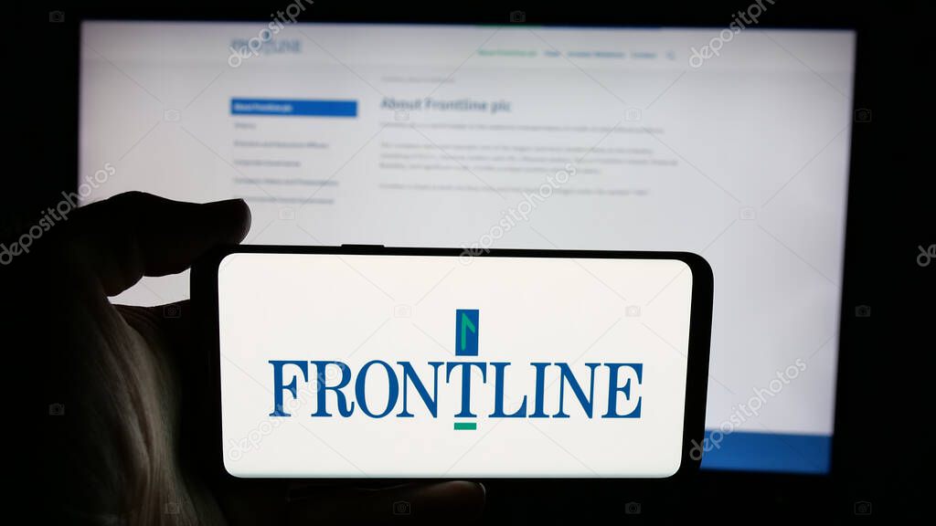 Stuttgart, Germany - 06-06-2025: Person holding cellphone with logo of oil tanker shipping company Frontline plc on screen in front of webpage. Focus on phone display.