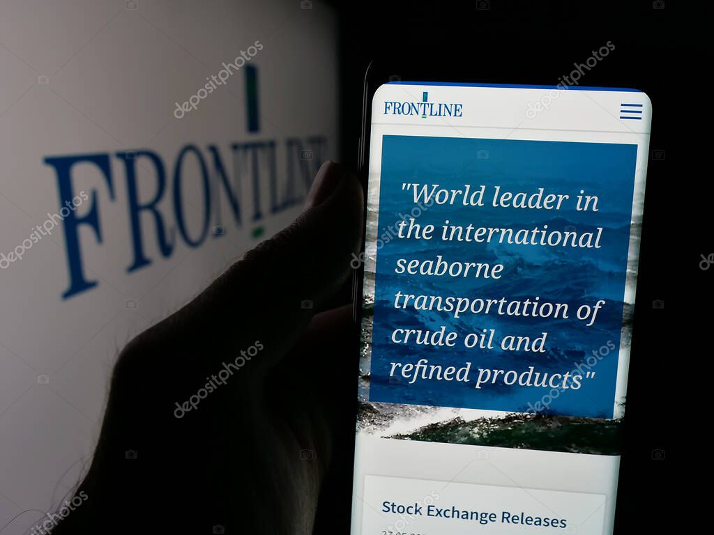Stuttgart, Germany - 06-06-2025: Person holding cellphone with webpage of oil tanker shipping company Frontline plc on screen in front of logo. Focus on center of phone display.